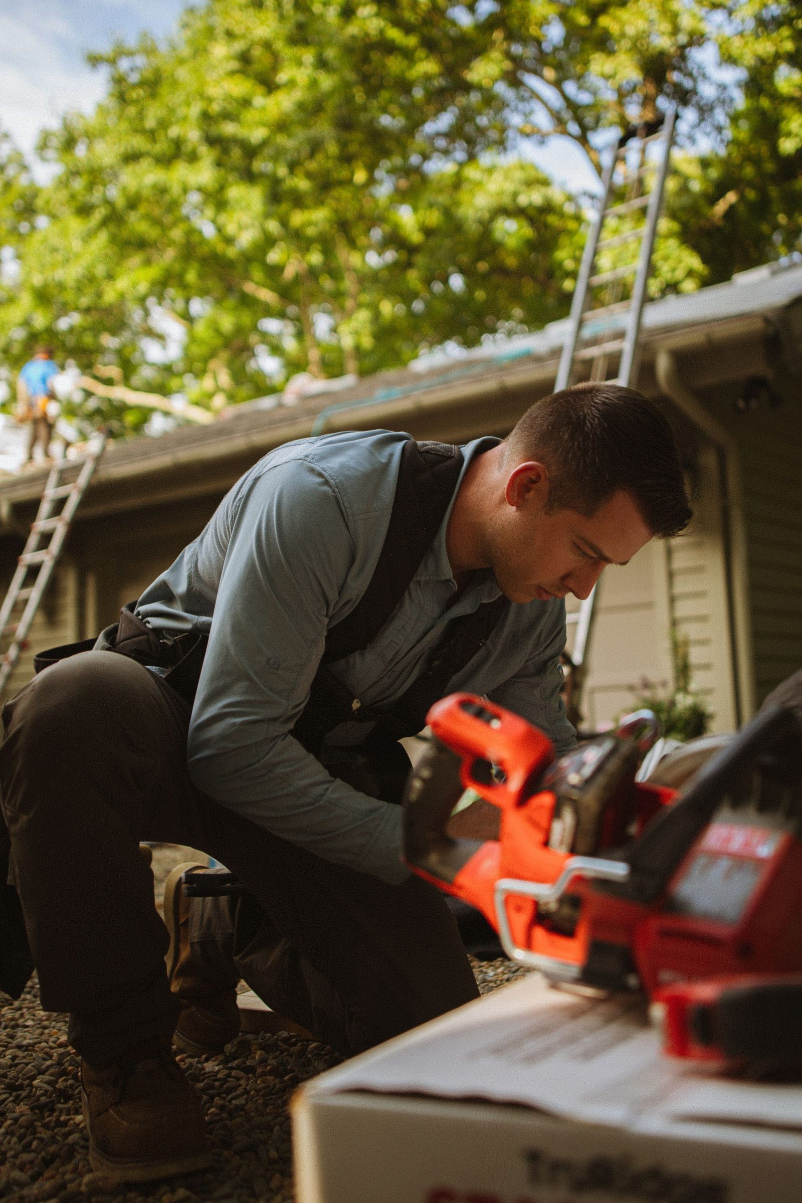 Roofer carrying out repair work at roof level